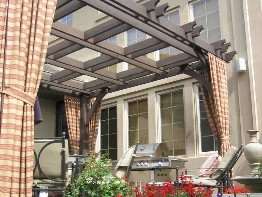 Custom pergola with curtains over a patio in Lowry
