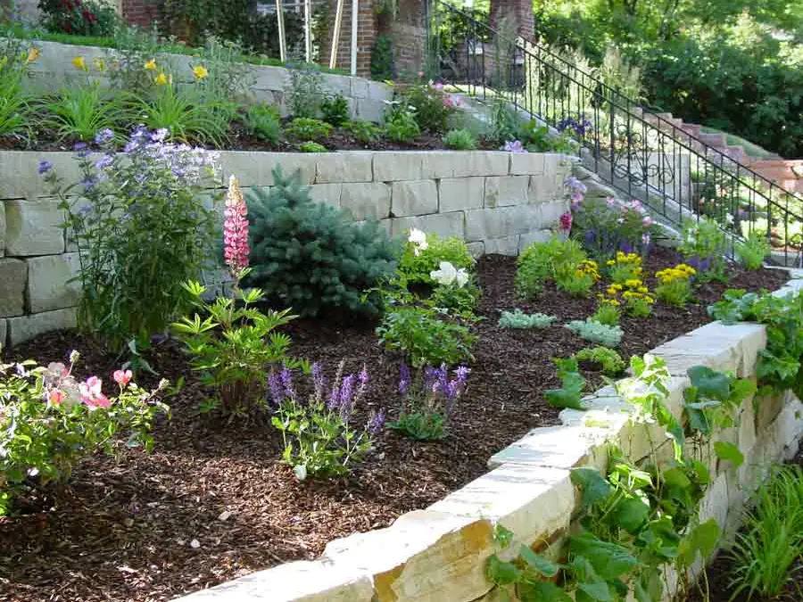 Three tiers of Colorado buff stone beds below a Washington Park bungalow