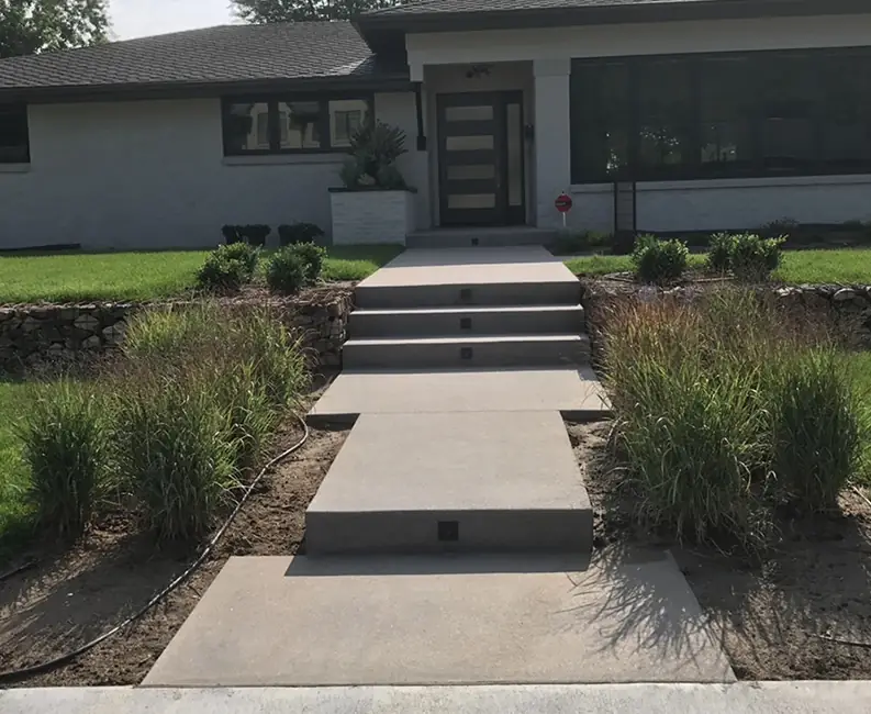 A modern front walk, before and after the new beds and planters. Before